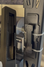 Close-up of a gun with a magazine attached, blurred background